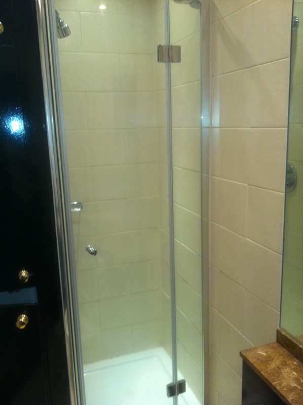 Frameless glass shower enclosure with chrome fittings in St John's Wood