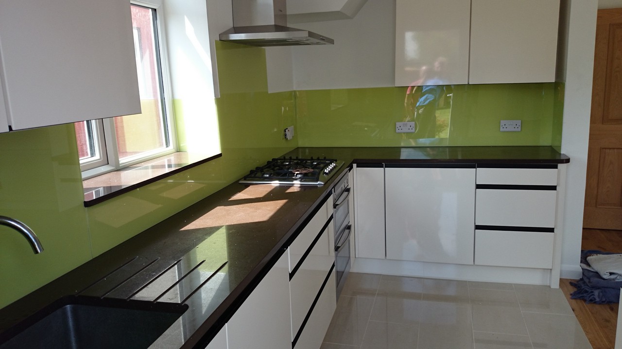 Lime green glass kitchen splashback installed by St John's Wood glaziers