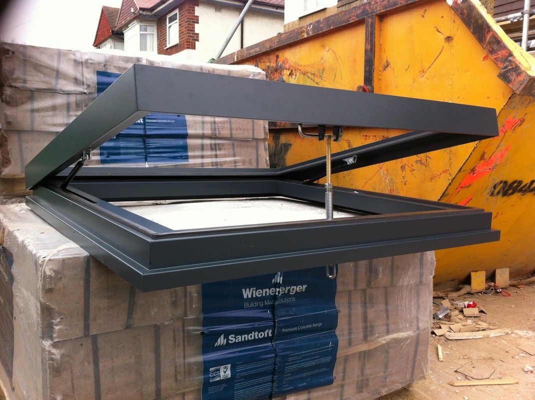 Opening flat roof skylight in anthracite grey installed in St John's Wood